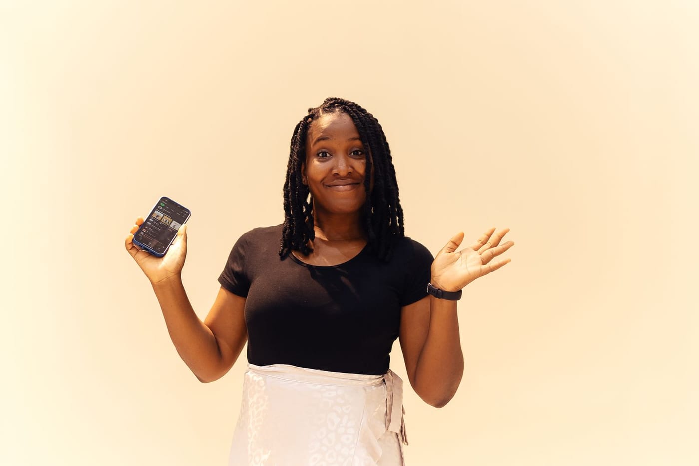 A smiling woman holding up her phone